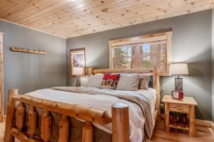 a bedroom with a wooden bed and a window at Beach House in Manitowish Waters