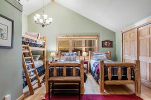 a bedroom with two bunk beds and a chair at Beach House in Manitowish Waters