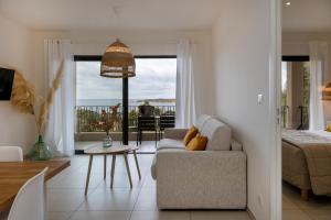 a living room with a couch and a view of the ocean at Casa Marina Cargèse in Cargèse