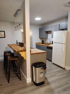 a kitchen with a counter and a white refrigerator at Near Venice Beach, sleeps 6, walk to river in Nokomis