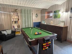 a living room with a pool table in a room at Demoiselle des Roches in Ramonchamp