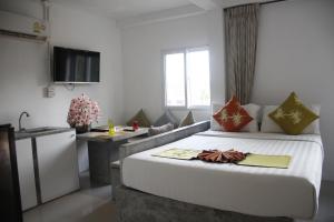 Postel nebo postele na pokoji v ubytování Samui Beach Residence Hotel