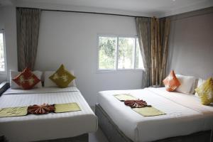Postel nebo postele na pokoji v ubytování Samui Beach Residence Hotel