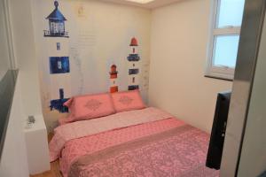 Llit o llits en una habitació de Fong Che Ho Hau Summer House