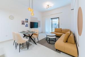 a living room with a couch and a table at FAM Living - Al Safa Residences - SZR in Dubai