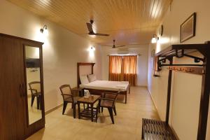 a room with a table and chairs and a dining room at Hotel Orfil in Calangute