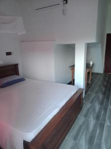 A bed or beds in a room at Sun Rest Mirissa