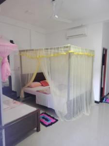 A bed or beds in a room at Sun Rest Mirissa