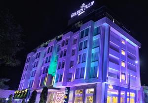 a building with purple and green lights on it at Golden Tulip Essential Jaipur in Jaipur