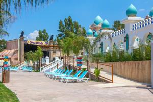 a row of lounge chairs at a resort at Orka Sunlife Resort Hotel and Aquapark in Oludeniz