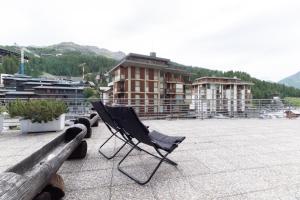 a chair sitting on the roof of a building at Bilocale in centro con terrazzo e wifi - AS11 in Breuil-Cervinia