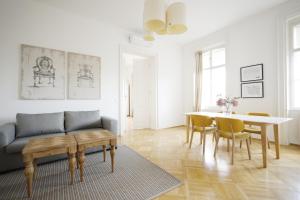 a living room with a couch and a table at HeyMi Apartments Oper in Vienna