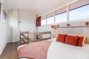 sypialnia z dużym łóżkiem z pomarańczowymi poduszkami w obiekcie Dunewave - spacious house for 8 persons in Westende w mieście Middelkerke