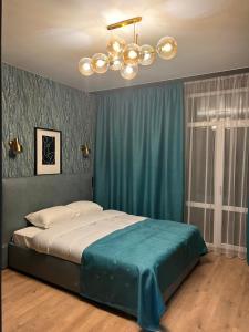 リヴィウにあるApartments Lux in city center Lvivのベッドルーム1室(ベッド1台、シャンデリア付)