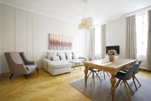 uma sala de estar com uma mesa e um sofá em HeyMi Apartments Karlsplatz em Viena