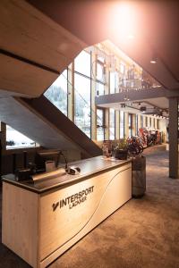 a restaurant with a counter in the middle of a building at Appartementhaus Lackner in Grossarl