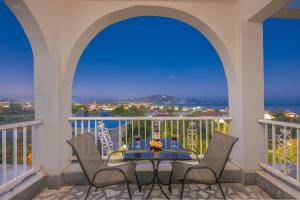 a patio with a table and chairs on a balcony at Panorama in Laganas