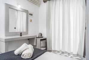 a bedroom with a bed with a sink and a mirror at Panorama in Laganas +36 photos