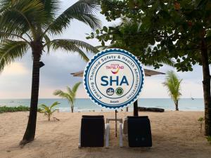 a sign for a sharmaarmaarma restaurant on the beach at Naiyang Seaview Place Resort in Nai Yang Beach