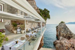 a restaurant with a view of the water at Blanche Cliff Apartments in Sveti Stefan