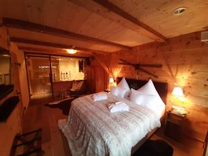 a bedroom with a bed in a log cabin at Superior Suite Bergparadies Sauna - barrierfree in Inzell