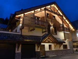 a house with lights on the side of it at Chalet Sétaz in Valloire