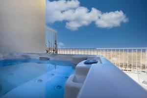 a swimming pool with a view of the sky at The Barrister in Valletta