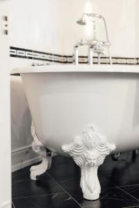 a bathroom with a sink and a white bath tub at Dormy House in Étretat