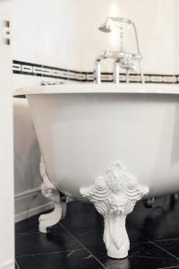 a white bath tub sitting in a bathroom at Dormy House in Étretat