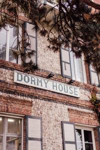 a sign on the side of a brick building at Dormy House in Étretat