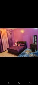 a bedroom with a bed in a pink room at Villa Suria SemiD Homestay Shah Alam in Shah Alam