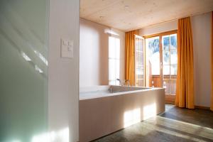 a bathroom with a sink and a large window at Hotel Silberhorn in Lauterbrunnen