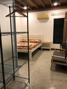 a room with a bedroom with a bed and shelves at Bluefin Guesthouse in Bangkok
