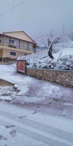 a person jumping off a wall in the snow at POLYTIMI HOUSE in Kalavrita