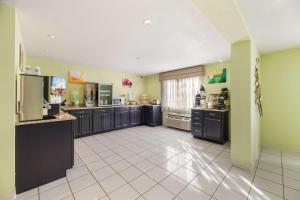 a large kitchen with black cabinets and appliances in it at Quality Inn Clovis in Clovis