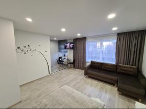 a living room with a couch and a table at Crystal Twin Apartment in Gulbene