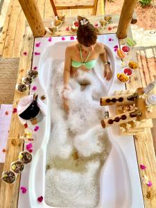 une femme dans une baignoire remplie d'eau dans l'établissement Rock and Sea Resort, à Watamu