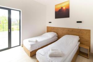 Postel nebo postele na pokoji v ubytování Hotel Konopielka