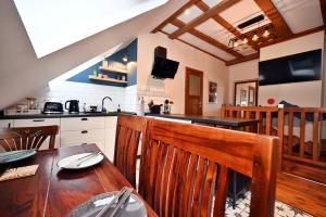 a kitchen with a wooden table and a dining room at Pokoje na Jasnej in Szczyrk