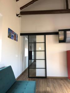 a living room with a loft bed with a blue couch at Mirador de San Juan in Toledo