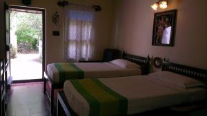 Postel nebo postele na pokoji v ubytování Indeco Hotels Swamimalai
