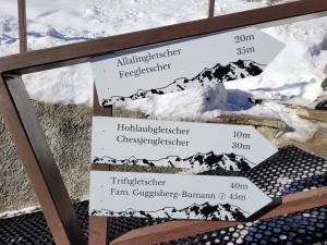 a sign with the names of the snow covered mountains at Chalet Ideal Saas-Fee in Saas-Fee