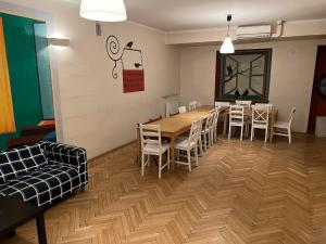 a dining room with a wooden table and chairs at 50 People Bis Apartment in Kraków +23 photos