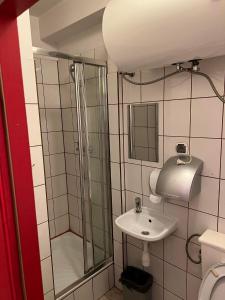 a bathroom with a shower and a sink at 50 People Bis Apartment in Kraków