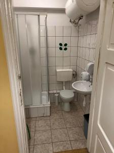 a bathroom with a toilet and a sink at 50 People Bis Apartment in Kraków