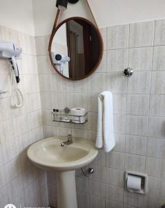 a bathroom with a sink and a mirror at Shellter Hotel in Holambra