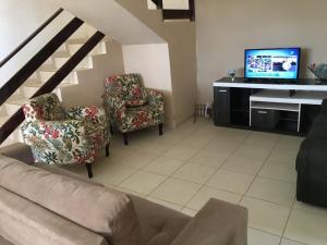 TV a/nebo společenská místnost v ubytování Arembepe