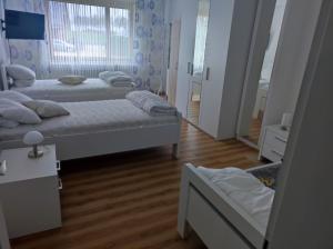 a room with two beds and a mirror in it at Wiehenblick in Hüllhorst