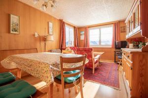 a kitchen and dining room with a table and chairs at Chalet Methfessel by Arosa Holiday in Arosa