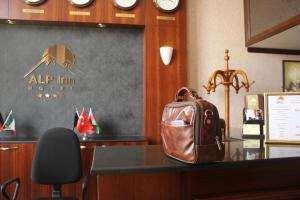 a brown purse sitting on a desk in a office at Alp Inn Hotel in Baku